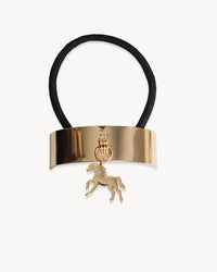 Gold hair tie with a horse charm on a white background