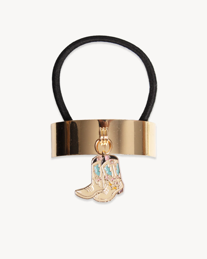Hair elastic with gold clasp and cowboy boot charm on a white background