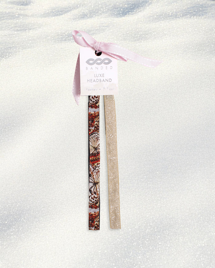 Two headbands, one with a butterfly pattern and one plain beige, on a white background.